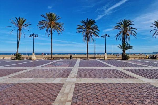 Playa de la Malvarrosa con amplia arena dorada y mar en calma